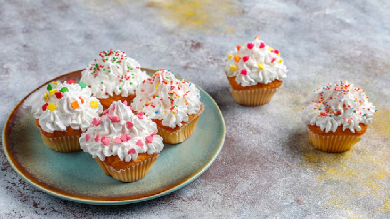 Make a big, red fondant heart in the center of a white frosting that is covered with little white pearlescent sprinkles all over.